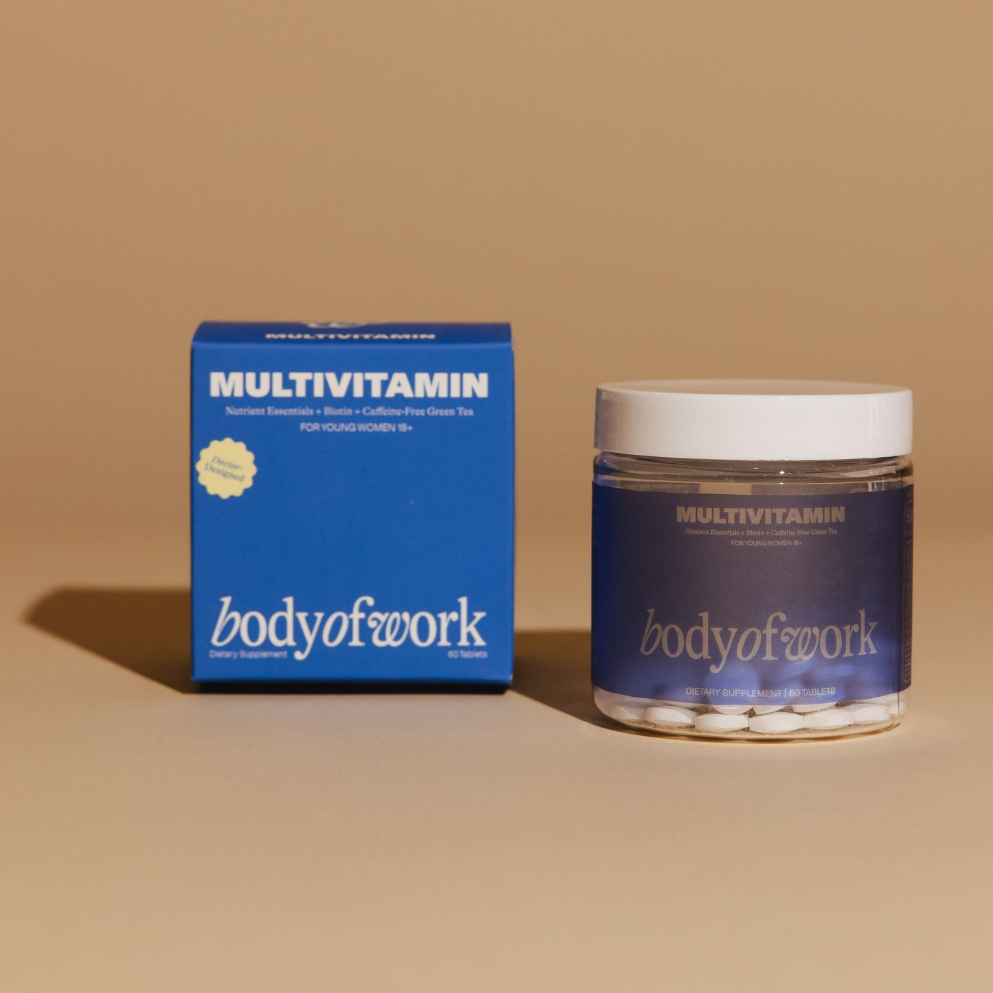 Jar and box of 'bodyofwork' multivitamin on a beige background